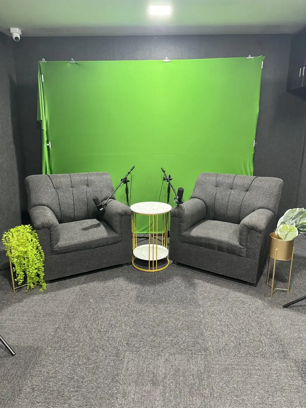 Green screen bay with two chairs and mics